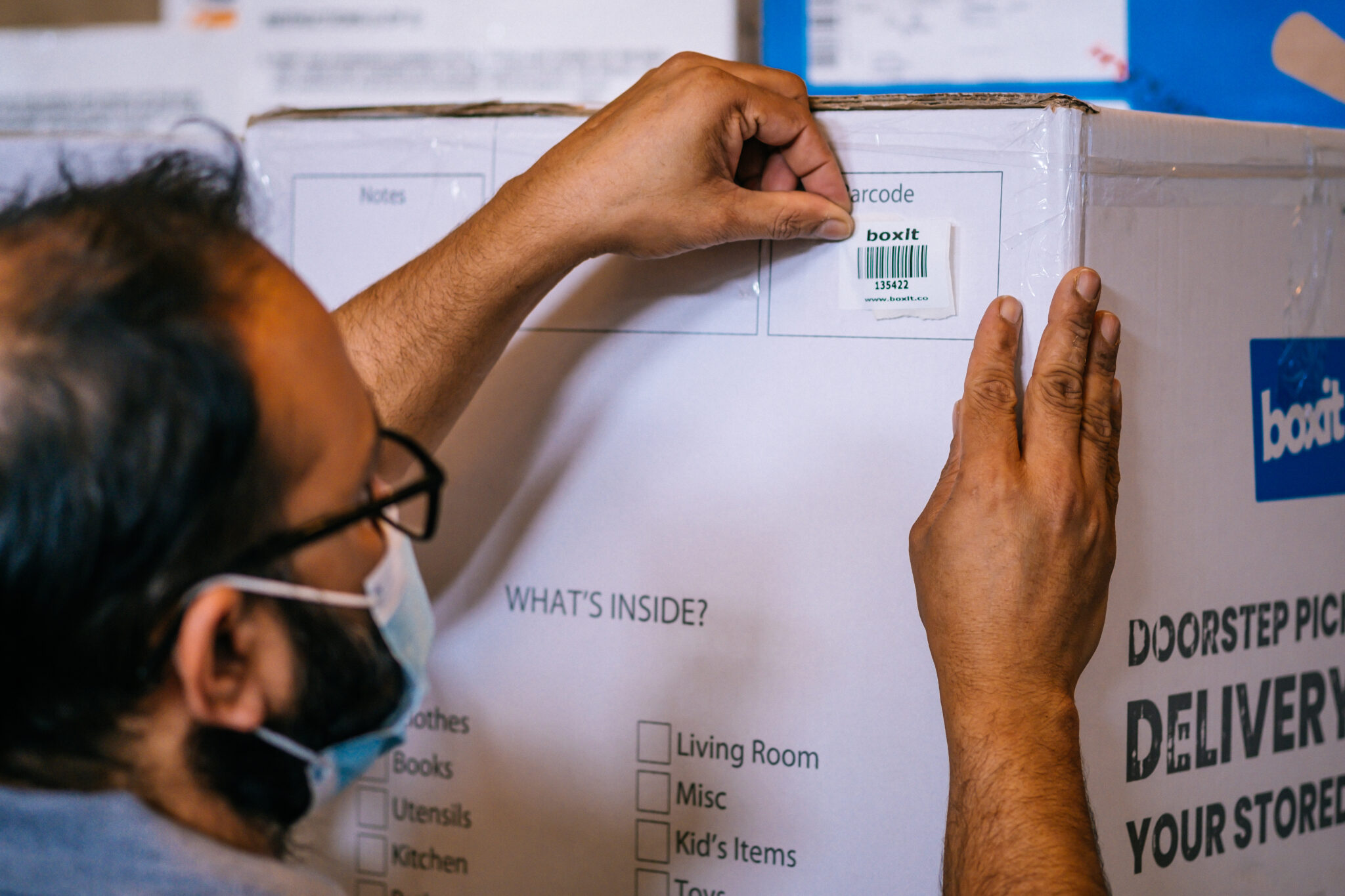 A Boxit team member labelling a customer's storage box